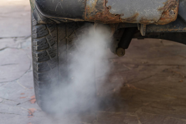 the toxic exhaust of a car badly spoils the environment - Photo, Image
