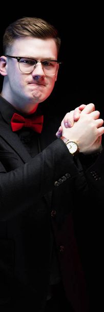 Portrait of confident handsome serious elegant responsible businessman showing fist on black background - Photo, image