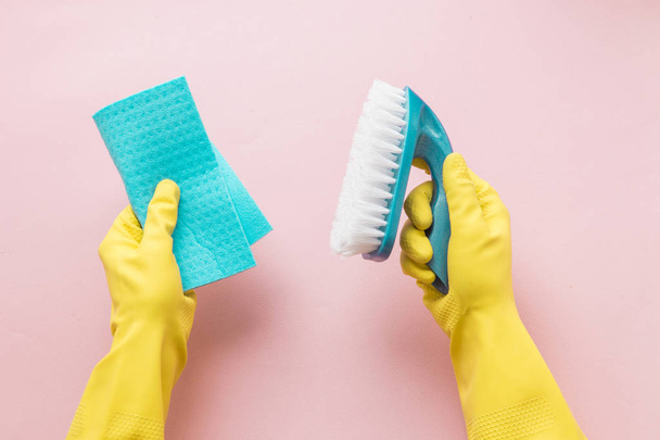 Flat lay Detergents and cleaning accessories and womens hands in rubber gloves in pink color. Cleaning service concept. Flatlay, Top view. - Fotoğraf, Görsel