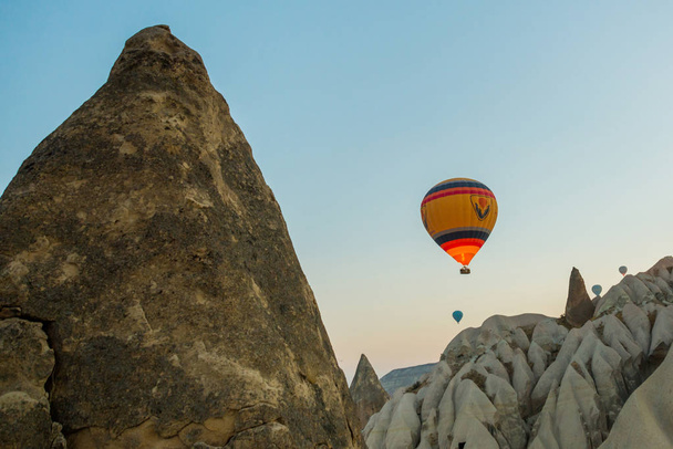 Many colorful hot air balloons flight above mountains - panorama of Cappadocia at sunrise. Wide landscape of Goreme valley in Cappadocia - billboard background for your travel concept in Turkey. - Zdjęcie, obraz