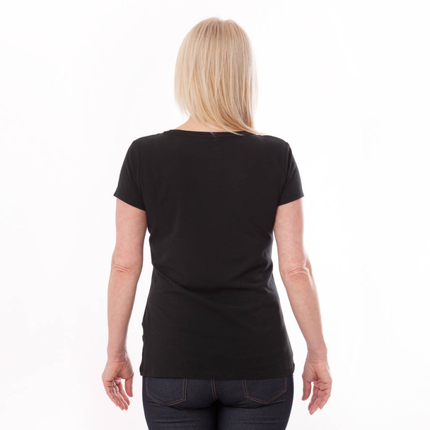 T-shirt design and people concept - close up of woman in blank black t-shirt, shirt rear isolated. Mock up. - Foto, Bild