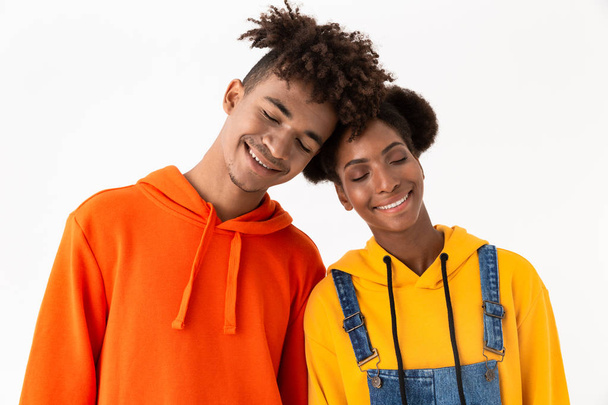 Image of african american brother and sister in colorful clothes standing together head to head isolated over white background - Fotografie, Obrázek