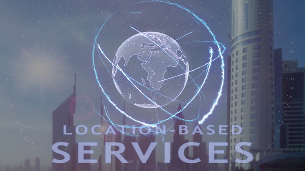 Location-based services text with 3d hologram of the planet Earth against the backdrop of the modern metropolis - Footage, Video