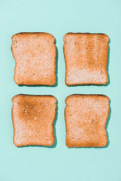 top view of assembled crunchy toasts on blue surface - Fotografie, Obrázek