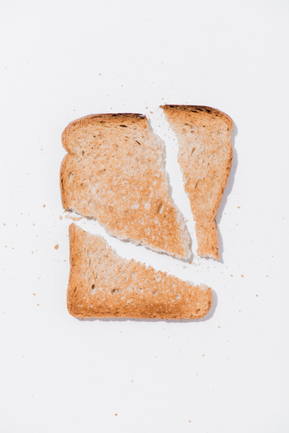 top view of teared toast on white surface - Фото, зображення