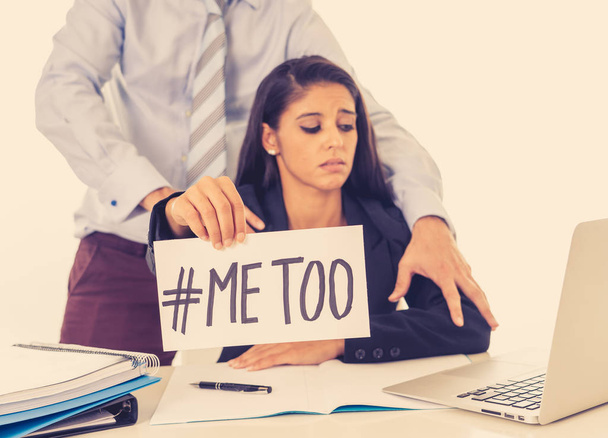Me Too Harassment Campaign. Young businesswoman being sexually harass by her boss in the office holding a note with the text me too in stop sexual abuse women human rights concept. - 写真・画像