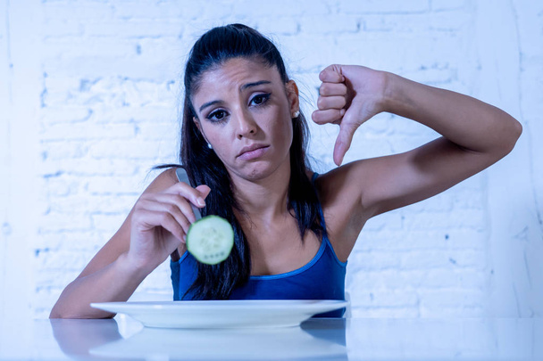 Portrait o f young attractive woman feeling sad and bored with diet not wanting to eat vegetables or healthy food in Dieting Eating Disorders and weight loss concept. - Foto, Imagem