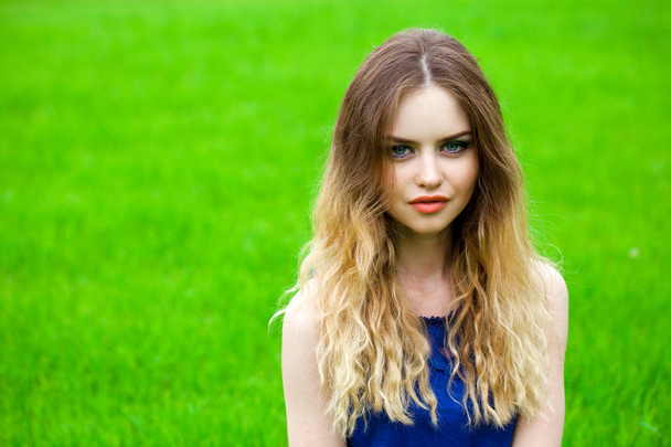 Portrait of beautiful young blonde woman, against summer green park. - Valokuva, kuva