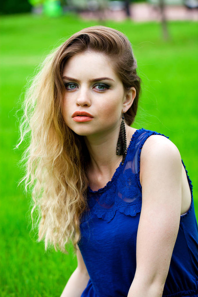 Portrait of beautiful young blonde woman, against summer green park. - Fotoğraf, Görsel