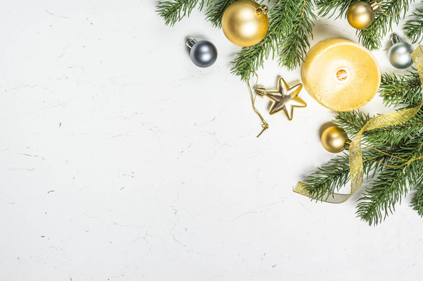 Gold  candle and decorations with fir tree on white  background. - Foto, Bild