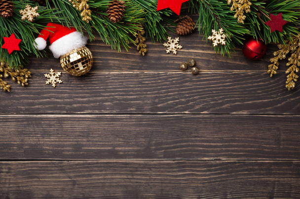 Christmas composition with decorations on wooden background. Copy space. Top view  - Foto, Bild