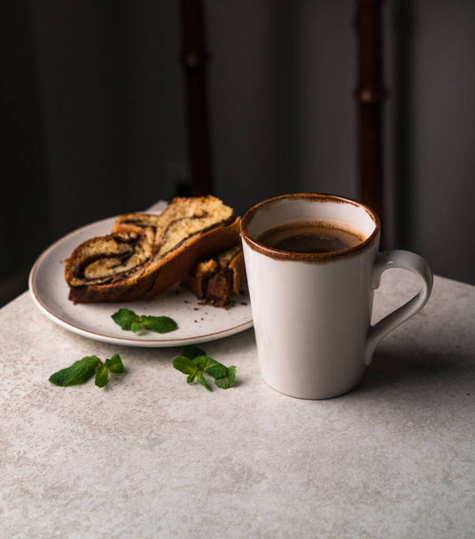breakfast at home, black coffee, chocolate brioche bread on grey marble table, dark background - Φωτογραφία, εικόνα