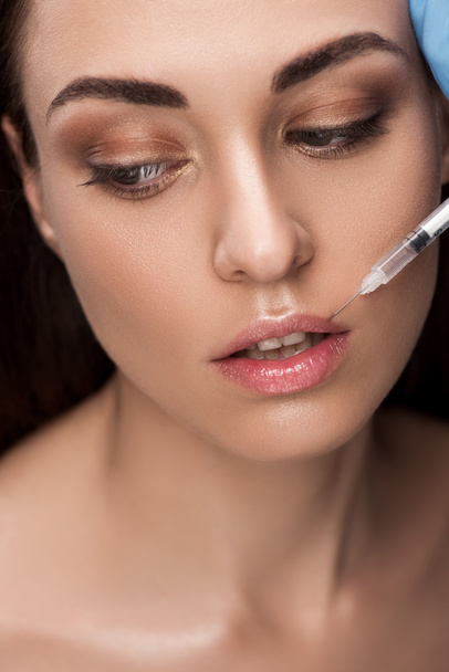 beautiful woman making beauty injection into lips - Foto, imagen