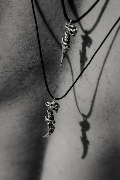 Silver cat shape pendants on woman back - Zdjęcie, obraz