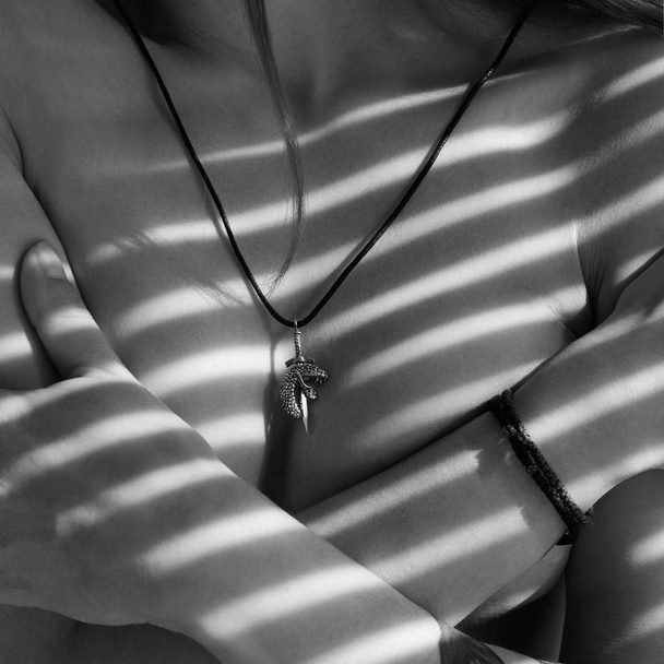 Sword snake silver pendant on naked woman body - Фото, зображення