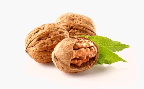 Walnuts with leaves isolated on white - Photo, Image