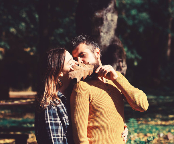 Girl and bearded guy or happy lovers on date kiss - Foto, afbeelding