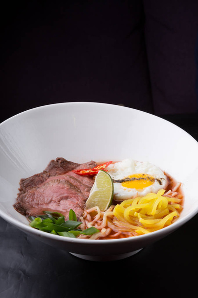 Asian ramen soup served with meat and fried egg - Foto, Imagem