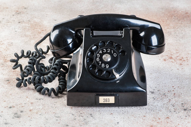 Antique black rotary phone on concrete background. Copy space for text. - Photo, Image