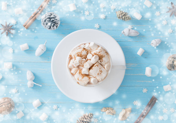hot chocolate with marshmallow on blue wooden background - Fotó, kép