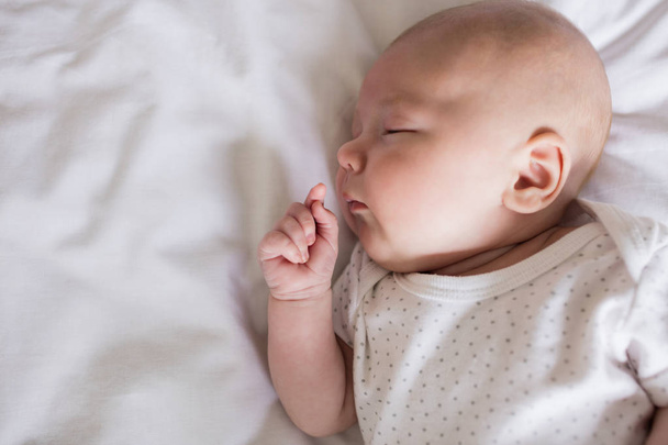 Baby sleeping on bed in bedroom at home - Photo, Image