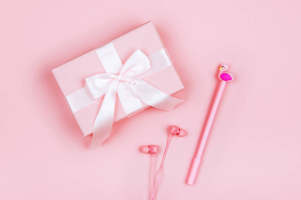 Holiday pink background with gift with headphones on colorful backgroud - Фото, зображення