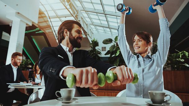Corporate Sport Lifestyle. Healthcare of Business People. Office Workers Working with Dumbbells. Workers doing Fitness Exercises. Yoga Practice. Employee Man Smiling to Healthy Woman. - Photo, Image