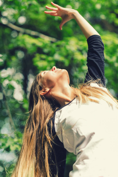 Positive young woman doing yoga outdoors - Foto, Imagem
