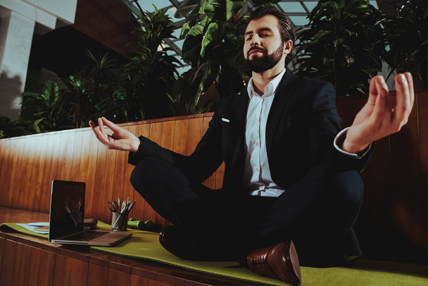 Sport Lifestyle. Healthcare of Business People.Yoga Practice. Employee Practicing on Bench in Office. Worker Sit in Lotus Pose. Man is Meditating. Person Relax. Male Keeps Calm. Zen Time. - Zdjęcie, obraz