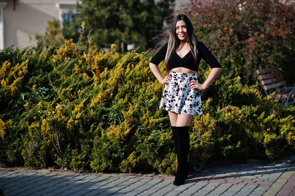 Bonita modelo latina de Ecuador vestida con tops negros y falda posada en la calle
.  - Foto, Imagen