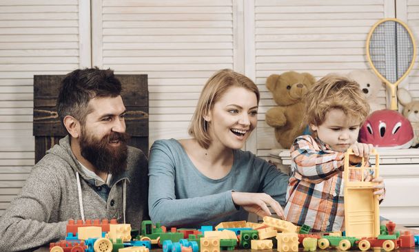 father and mother with child play constructor. happy childhood. Care and development. happy family and childrens day. Little boy with dad and mom. little boy play with parents at home. Family day - Фото, зображення