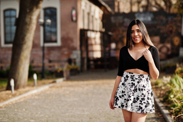 Pretty latino model girl from Ecuador wear on black tops and skirt posed at street.  - Photo, Image