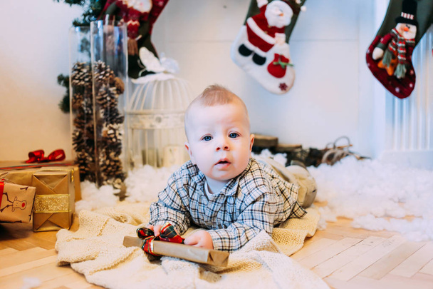 Christmas, holidays and childhood concept - boy with gift box at home - Φωτογραφία, εικόνα
