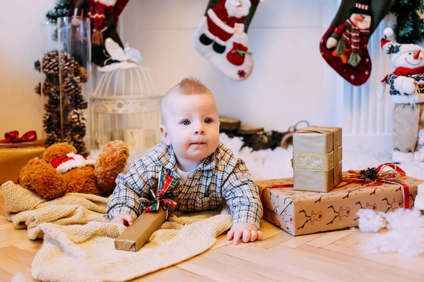 Boy with gift box at home. Merry Christmas and Happy Holidays - Φωτογραφία, εικόνα