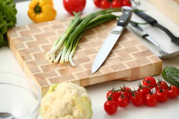 Knife and green onions for salad or fresh - Photo, image
