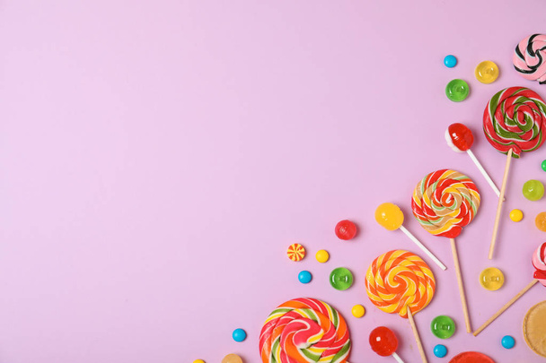 Flat lay composition with different candies and space for text on color background - Fotoğraf, Görsel