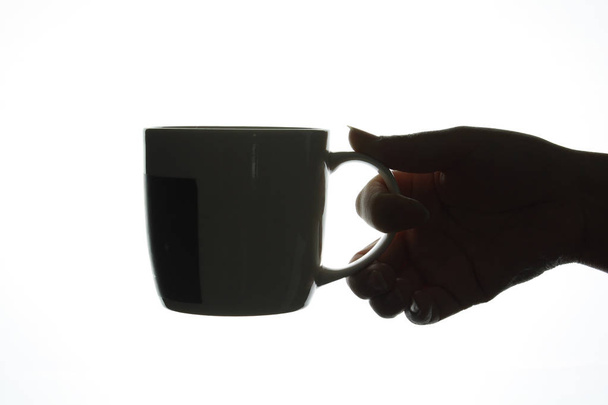 Hand holding cup silhouette - Foto, Imagem