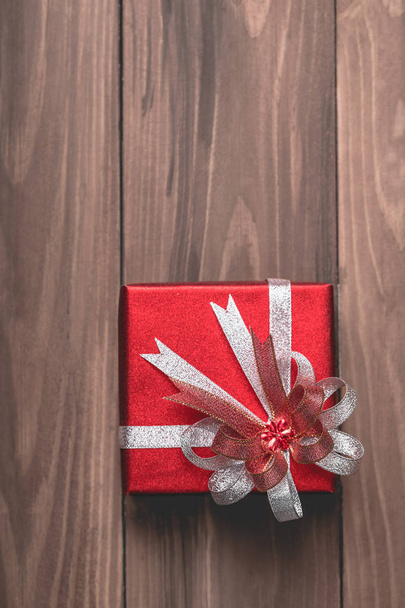 Ένα όμορφο κουτί παρόντες, κόκκινες και χρυσές διακοσμήσεις Χριστουγέννων τακτοποίηση στο μαλακό άκρο θολή για διάστημα αντίγραφο, το top view. - Φωτογραφία, εικόνα