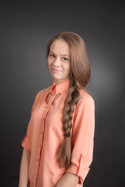 portrait of a girl with long hair on a black background - Photo, Image