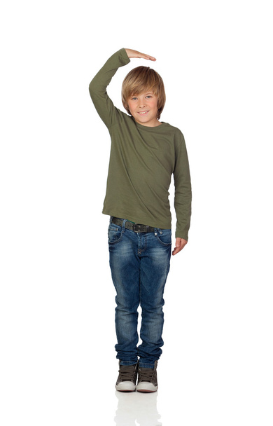 Happy preteen boy pointing measuring what has grown - Photo, Image