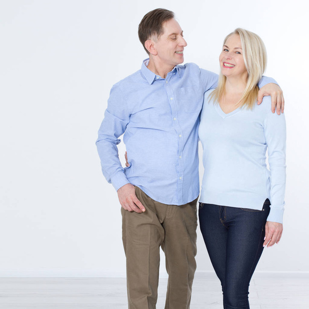 Full length portrait of happy mature couple standing with hands  - Photo, Image