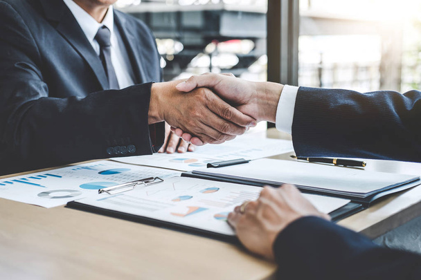 Teamwork partnership meeting concept, Two confident Business shaking hands after discussing good deal of trading contract and new projects for both companies. - Fotoğraf, Görsel