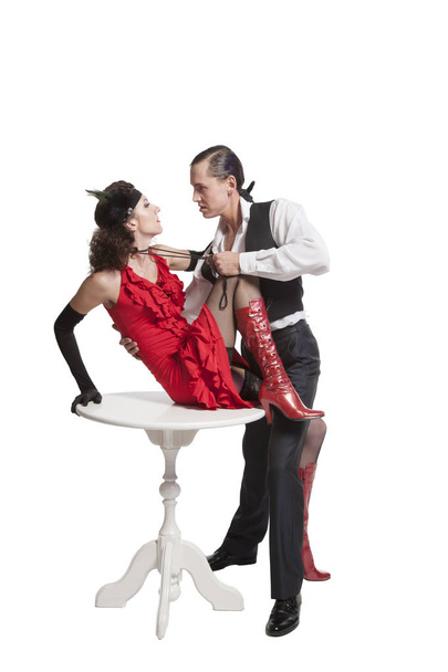 Молодой парень и девушка в стиле ретро исполняют танго в сексуальной позе, вырезанной на белом фоне и страстно любят друг друга
 - Фото, изображение