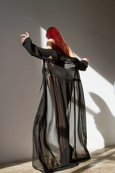 Red-haired girl in a long peignoir - Valokuva, kuva
