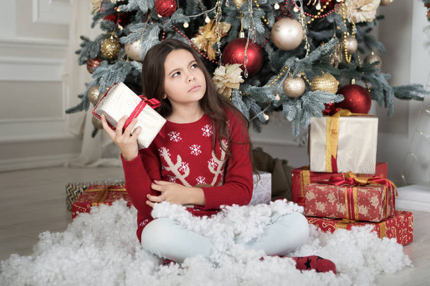 christmas family holiday. happy new year. Christmas shopping. waiting for santa. Xmas. The morning before Xmas. Cute little child girl with xmas present. what is inside - Photo, image