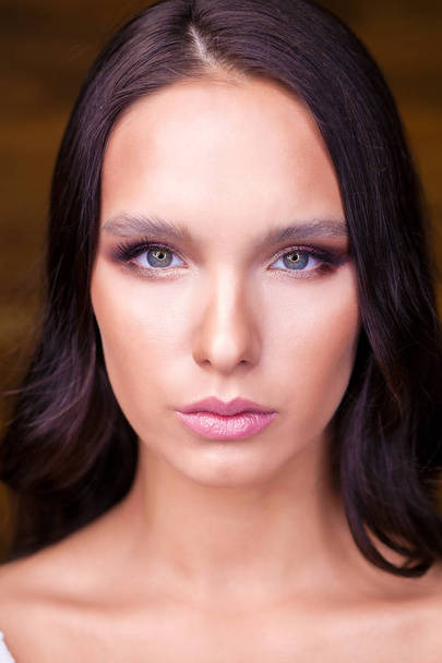 Close up portrait of young brunette girl with dark hair fashion gorgeous makeup - Fotó, kép