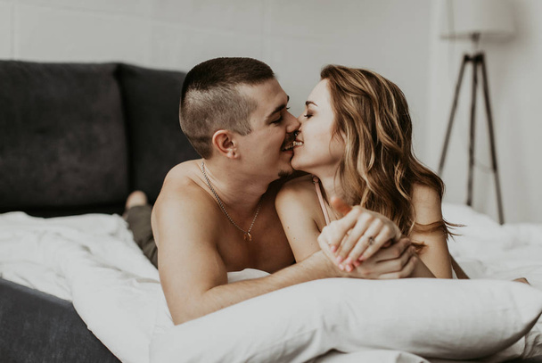 beautiful couple kissing in bed - 写真・画像