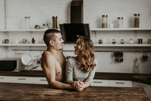 beautiful couple kissing in the kitchen - Foto, imagen