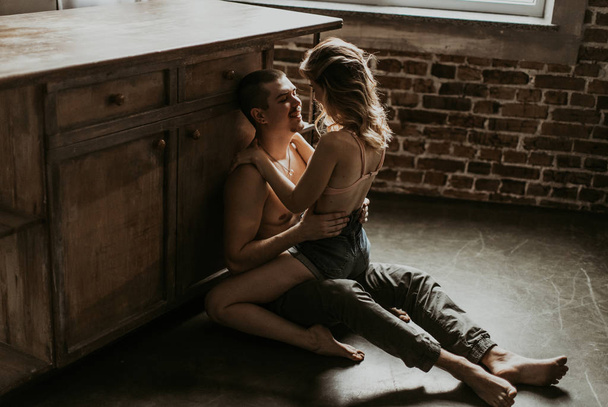 beautiful couple kissing in the kitchen - Фото, зображення