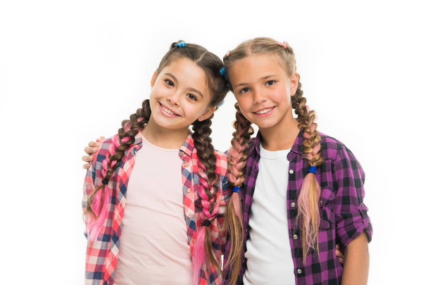 Trendy girls. Dress similar with best friend. Dress to match your friend. Best friend dressing. Friends wear similar outfits have same hairstyle braids white background. Sisters family look outfit - Foto, imagen
